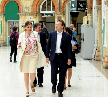 Caroline Ansell discussing train links in Eastbourne station with Grant Shapps